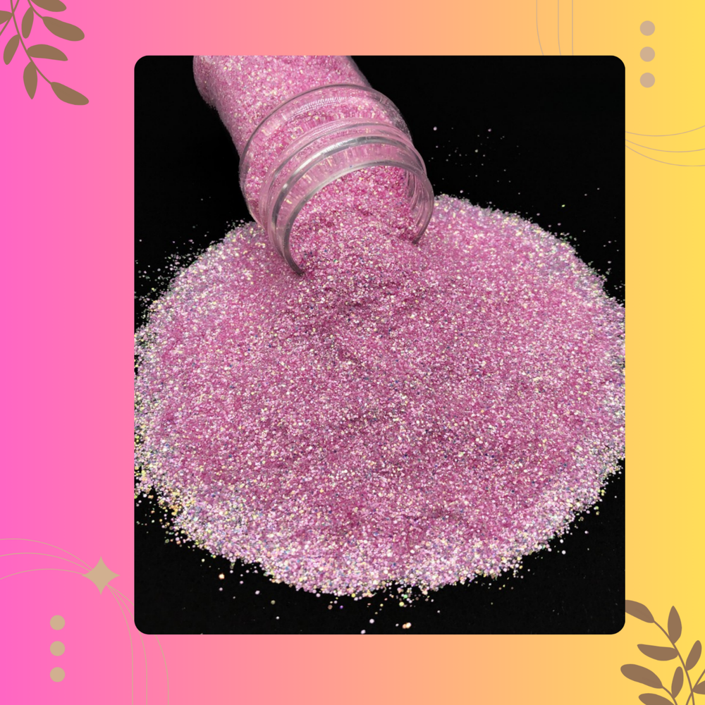 Pink glitter being poured from a container onto a black surface with a colorful border.