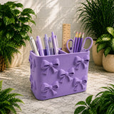 Purple pencil holder with stationery items on a marble surface with plants around