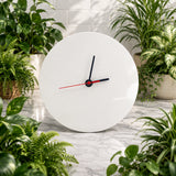 White wall clock with black and red hands on a marble surface surrounded by potted plants.