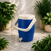 Blue and white cooler with a spigot surrounded by potted plants on a stone floor.