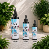 Three bottles of UV Resin on a stone surface with plants in the background