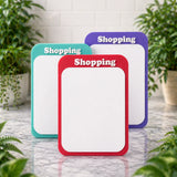 Three colorful magnetic dry erase boards on a marble surface with plants in the background.