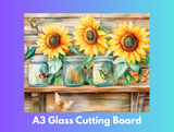 Decorative glass cutting board with sunflowers and jars on a wooden surface, featuring butterflies.