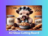 Glass cutting board with a cartoon bear and baking items, text 'Life is short, lick the spoon', on a gradient background.