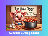Glass cutting board with a cartoon pig and bacon on a wooden background