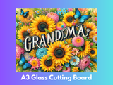 Decorative glass cutting board with flowers and butterflies featuring the word 'GRANDMA'.
