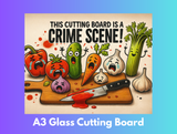 Cartoon vegetables on a cutting board with text 'This cutting board is a crime scene!' and 'A3 Glass Cutting Board' text at the bottom.