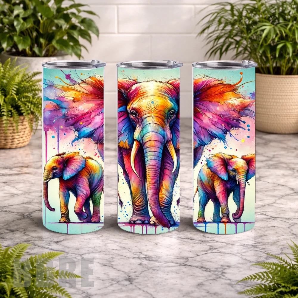 Three colorful elephant tumblers on a marble surface with plants in the background.