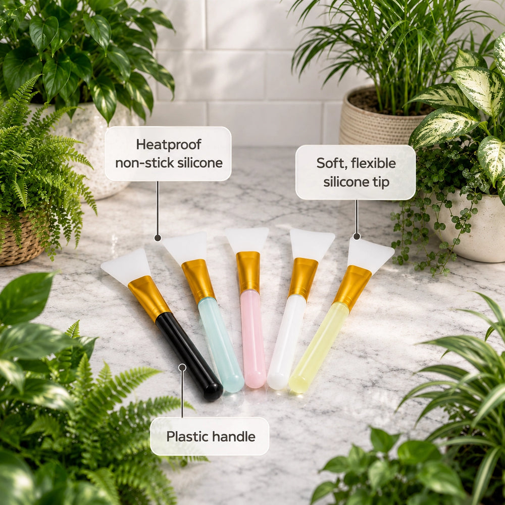 Set of silicone tools with labeled features on a marble surface surrounded by plants.
