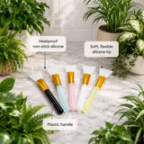Set of silicone tools with labeled features on a marble surface surrounded by plants.