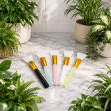 Set of plant cleaning brushes with colorful handles on a marble surface surrounded by potted plants.