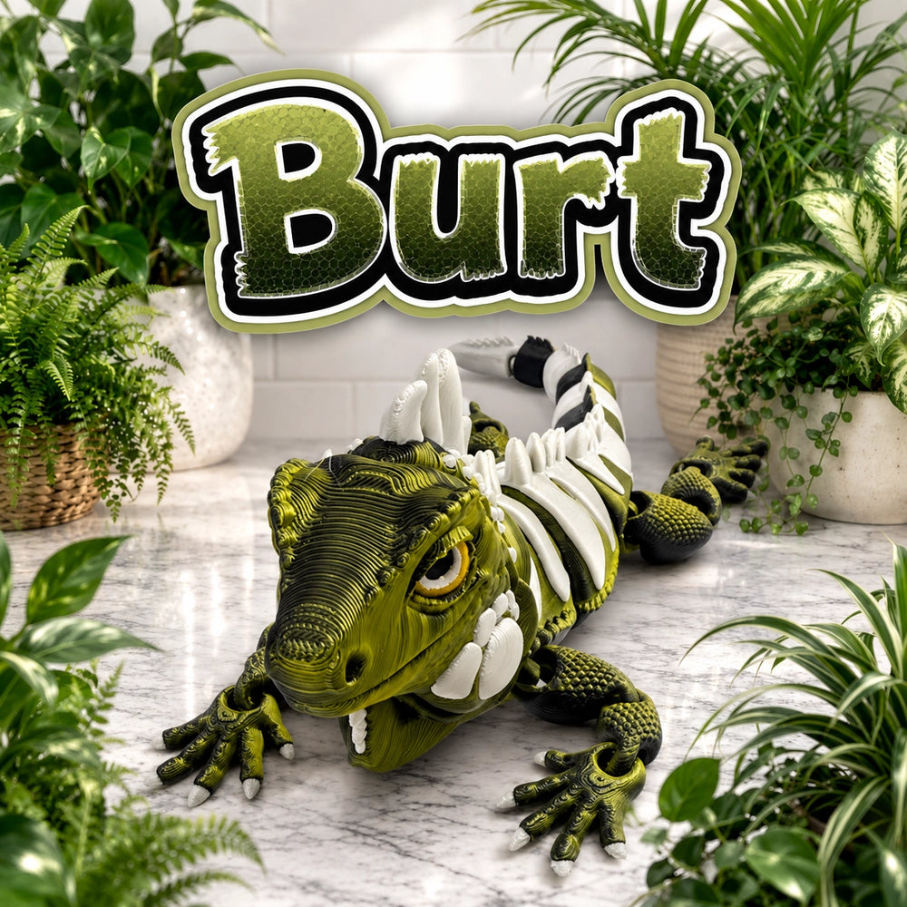 A green and black lizard toy with white spikes and teeth, posed on a marble-like surface surrounded by potted plants, with a large 'Burt' logo above it.