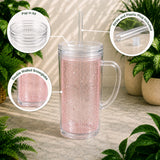 Clear tumbler with pink interior, lid, straw, and plug on a neutral background with plants.