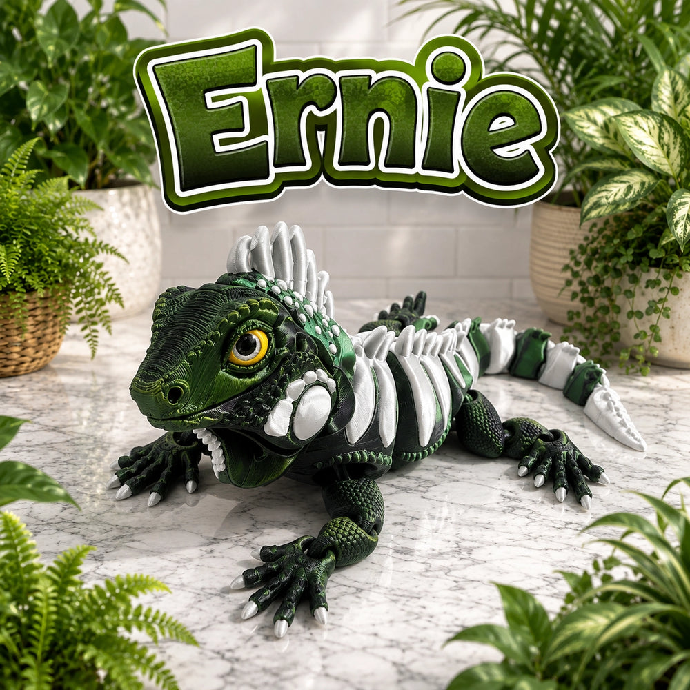 A green and white iguana toy with a yellow eye, positioned on a marble surface surrounded by potted plants, with a large 'Ernie' text overlay at the top.