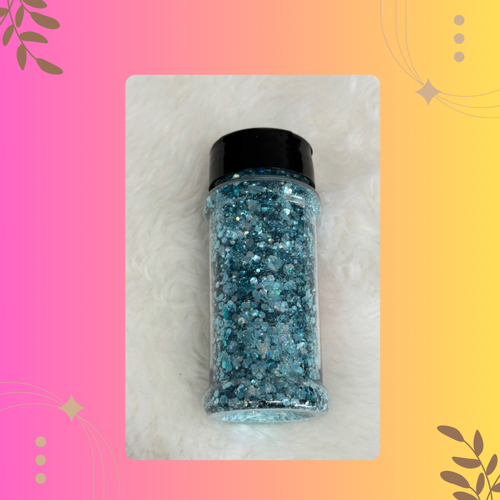 Bottle of blue glitter on a pink and yellow gradient background