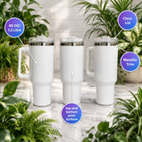 White travel mugs with clear lids and metallic trim on a marble surface with plants in the background.