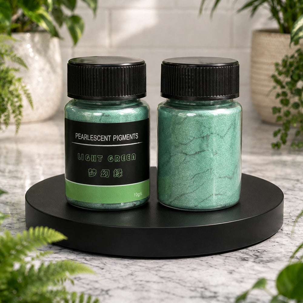 Two jars of light green pearlescent pigments on a black stand with plants in the background.