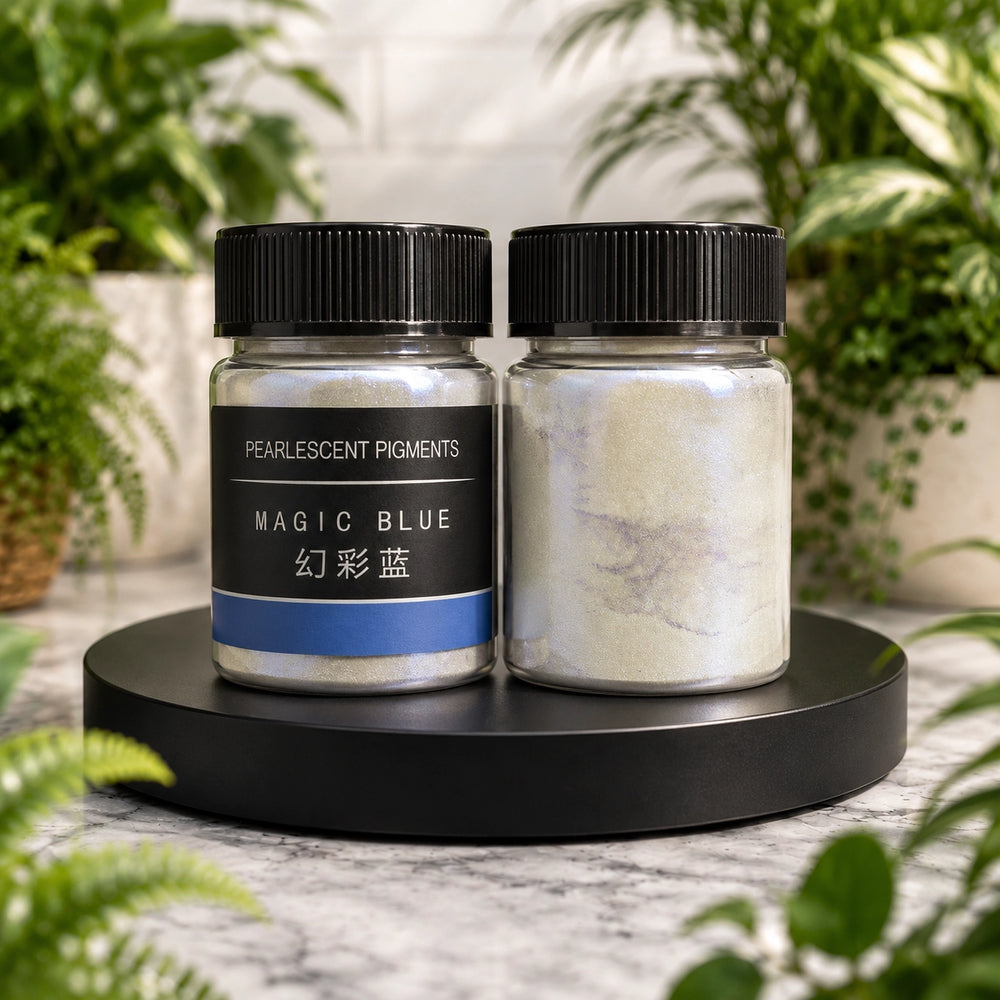 Two jars of pearlescent pigments on a black stand with plants in the background
