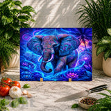 Colorful elephant artwork on a marble surface with vegetables and a knife.