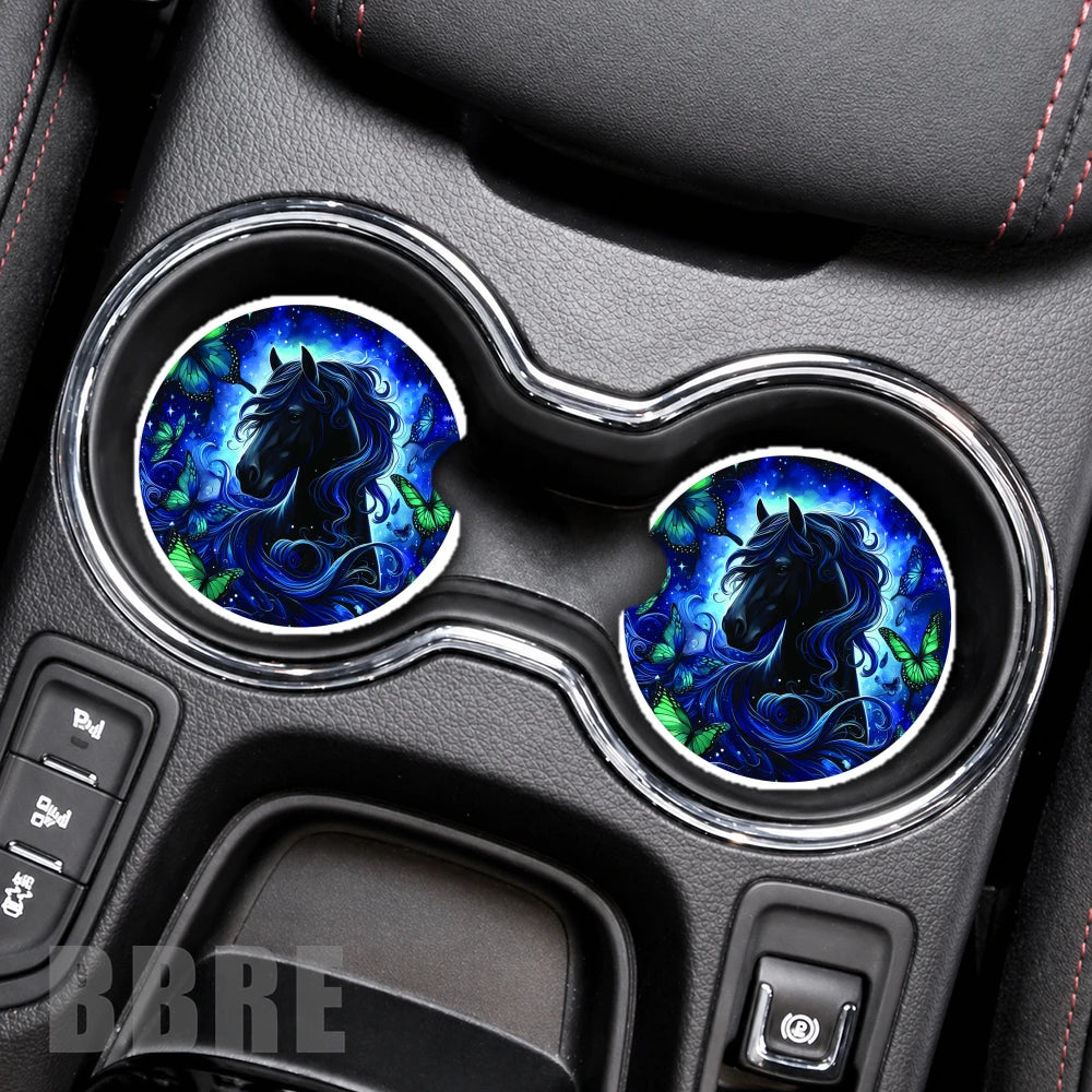 Car cup holder with blue and black horse design coasters on a gray dashboard.