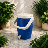 Blue and white cooler with a spigot surrounded by potted plants on a stone floor.