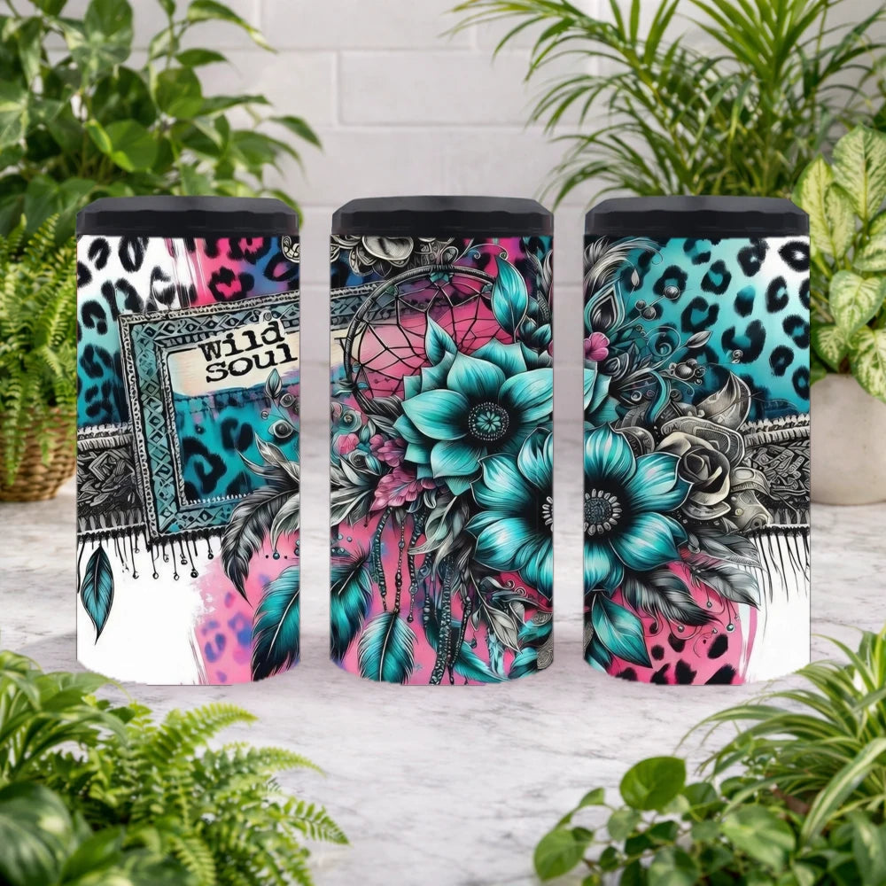 Three can coolers with colorful designs on a wooden surface with plants in the background