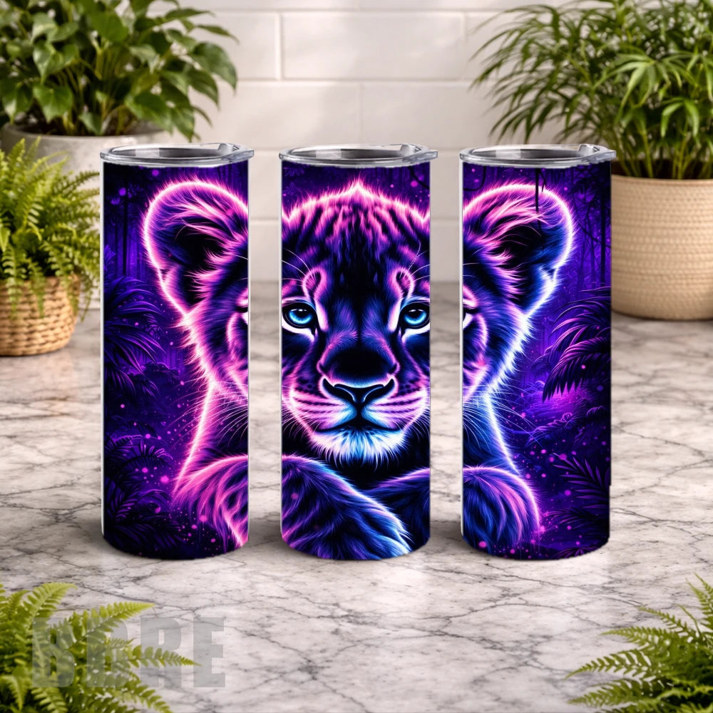 Three tumbler cups with a purple tiger design on a marble surface with plants in the background.