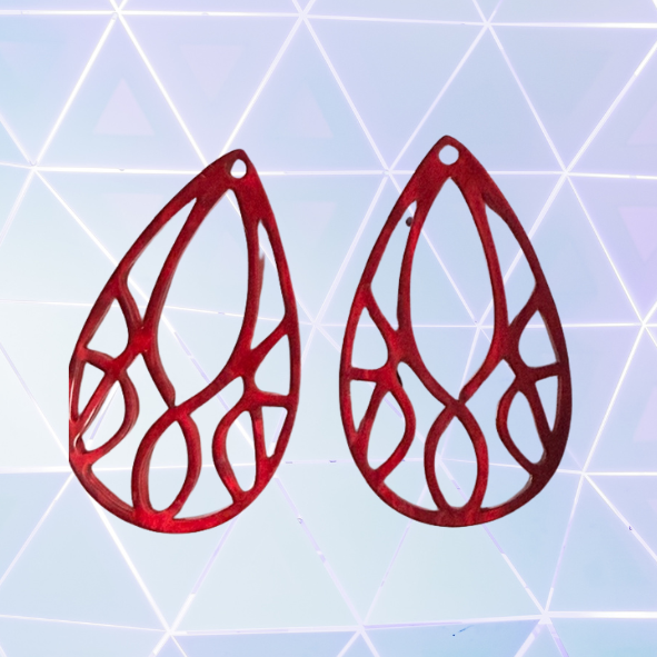 Red teardrop-shaped earrings on a geometric patterned background