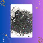 Black glitter with colorful specks spilling out of a container on a white background