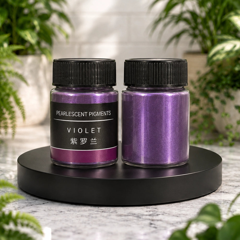 Two jars of pearlescent pigment labeled 'Violet' on a black stand with greenery in the background.