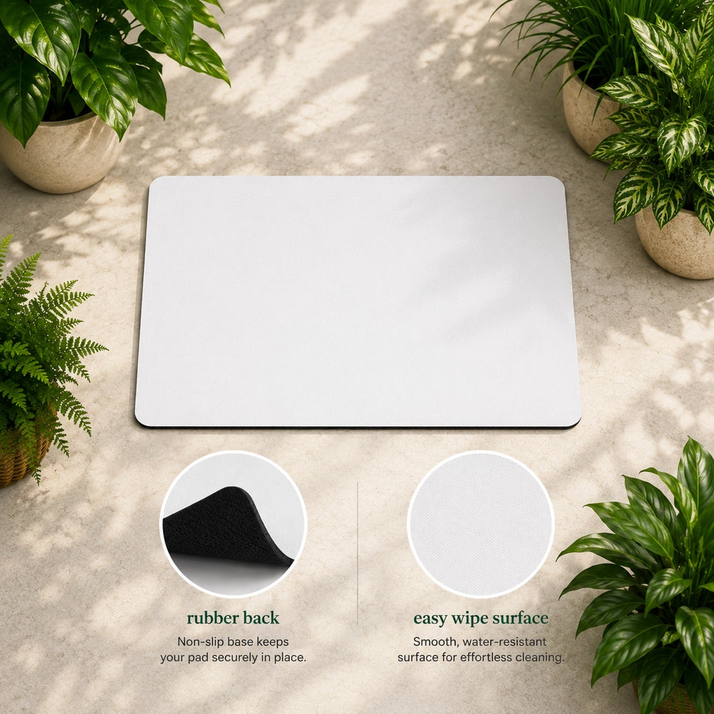 White mat with rubber back and easy wipe surface, surrounded by potted plants on a light wooden floor.
