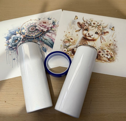 Two rolls of white vinyl with a printed design of a cow and flowers on a wooden surface.